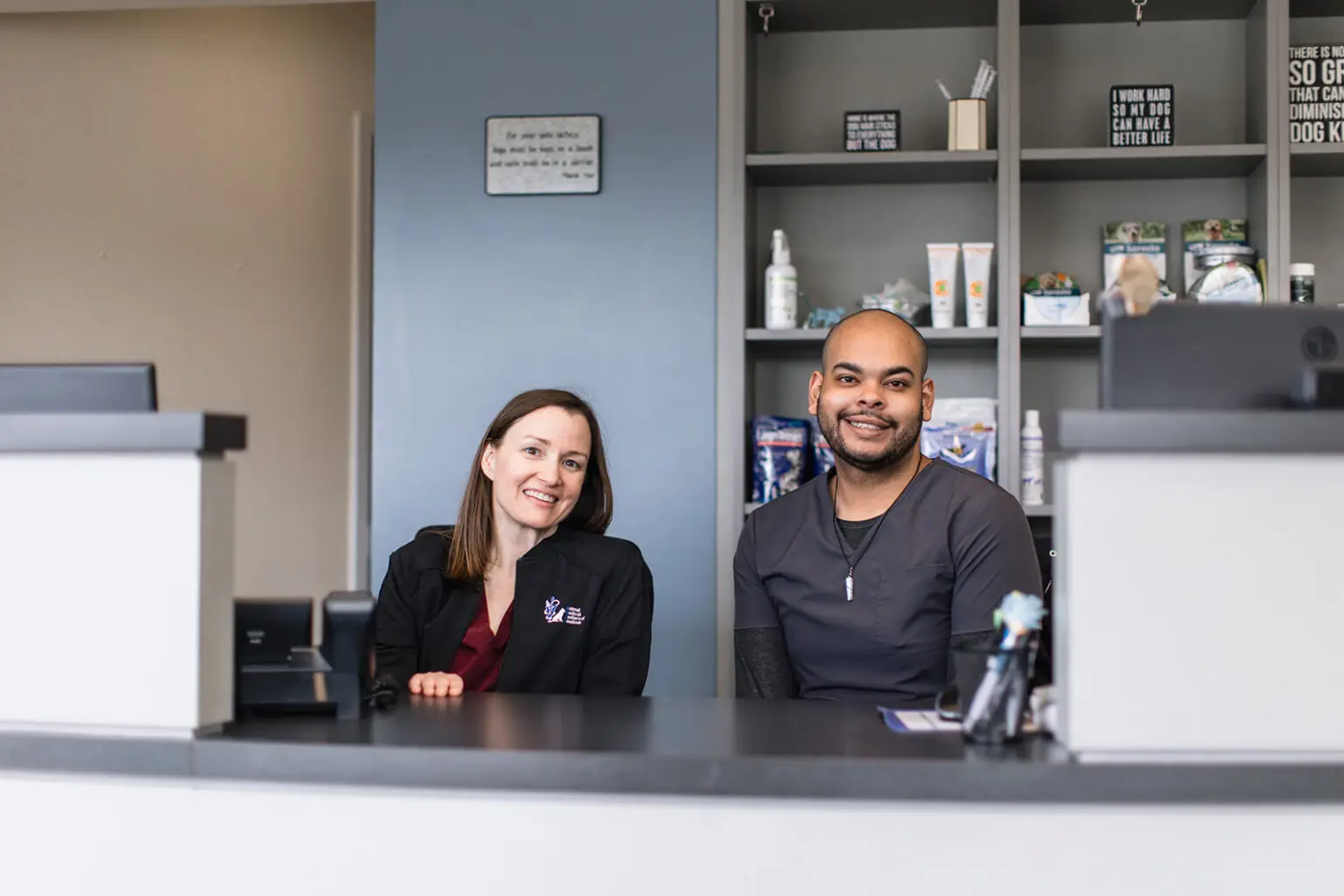 Smiling front desk staff at veterinary practice in Ashburn, VA and Brambleton, VA.